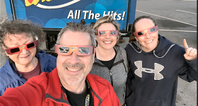 WZYP-FM/Huntsville: WZYP listeners picking up their free eclipse glasses and waiting for the solar eclipse with Steve Smith (in red WZYP shirt) on Monday. 